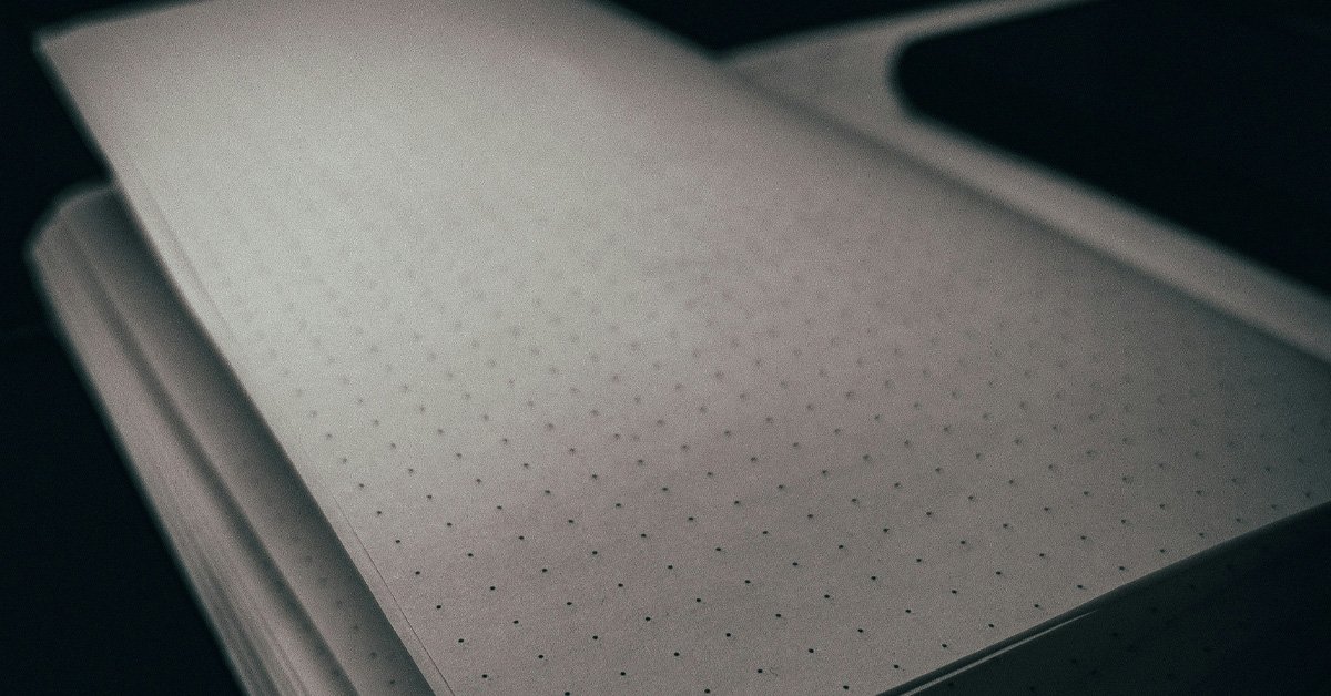 Open notebook with dotted pages in soft, low light