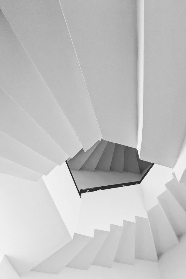 Low angle view of white spiral staircase.